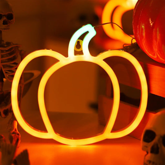 pumpkin-shaped neon sign with glowing orange and green light